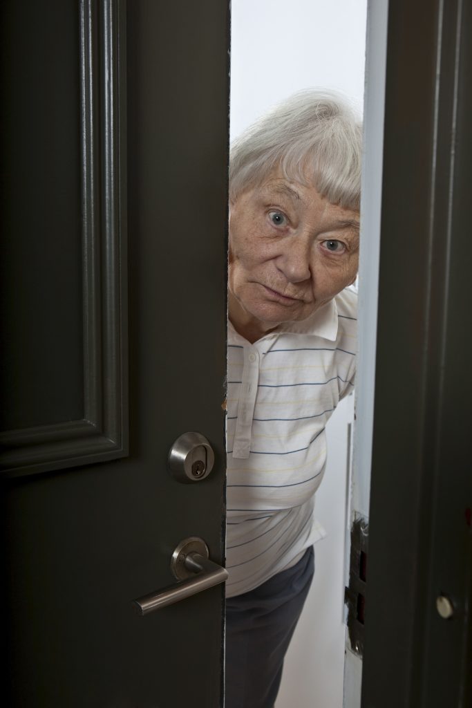 Older woman opening door